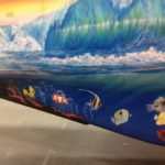 wave with fish on the Grand Caravan airplane painted by ArtCraft Paint in collaboration with John Stahr