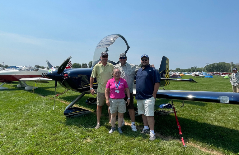 Teresa and clients with experimental plane at AirVenture in Oshkosh Wi